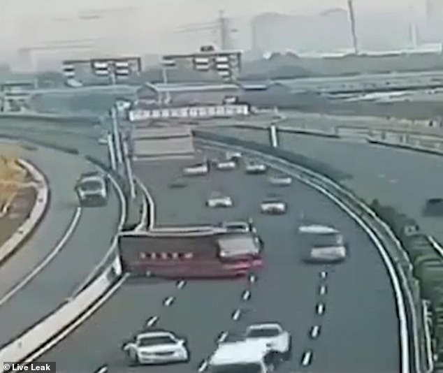 The clip, captured in China, shows a huge red bus screeching to a halt after the driver realises the vehicle will not fit through a toll booth